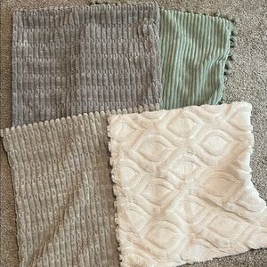 Four different pillow cases. Gray, green and beige pillow shams square pillows
